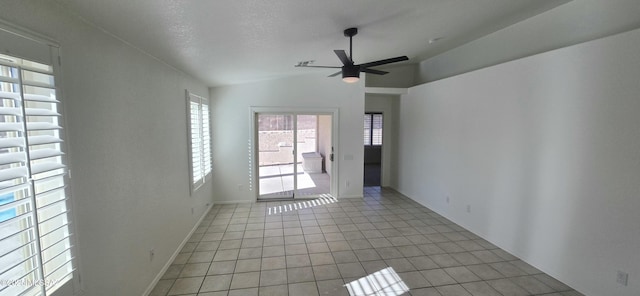 unfurnished room with vaulted ceiling, ceiling fan, a textured ceiling, and light tile patterned flooring