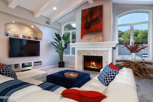 living room with carpet flooring, a tiled fireplace, and a wealth of natural light