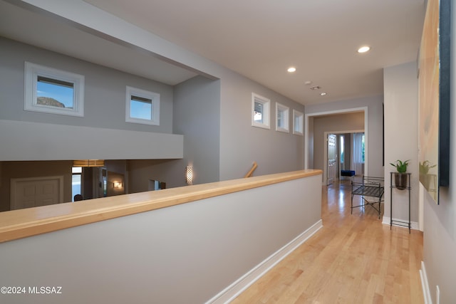 hallway with light hardwood / wood-style flooring