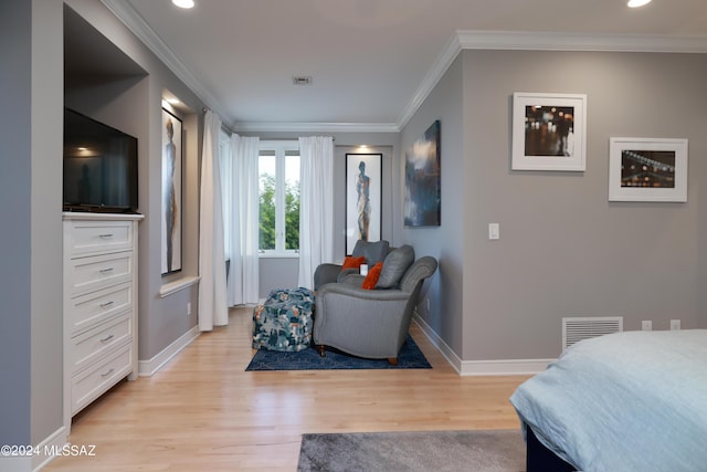 bedroom with crown molding and light hardwood / wood-style flooring