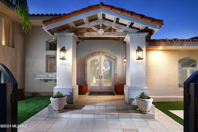 exterior entry at dusk with french doors