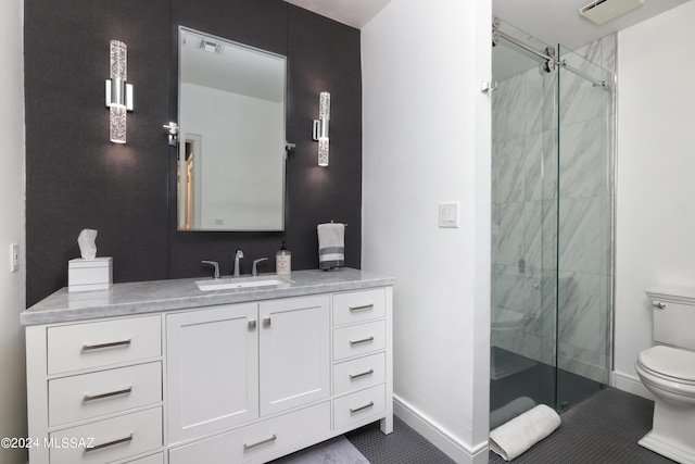 bathroom featuring tile patterned flooring, vanity, toilet, and a shower with shower door