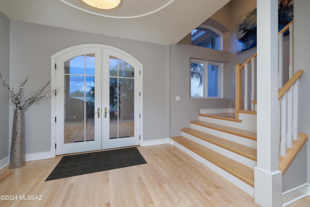 entryway featuring light hardwood / wood-style flooring and french doors