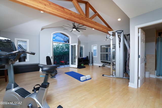 workout area featuring ceiling fan, light hardwood / wood-style floors, and lofted ceiling