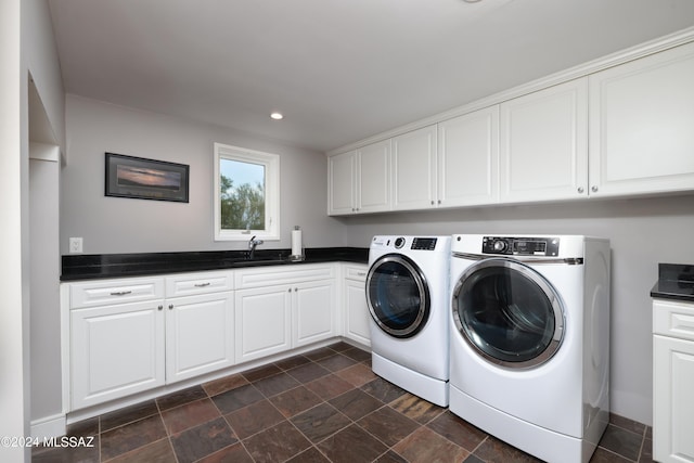 laundry area with sink, cabinets, and independent washer and dryer