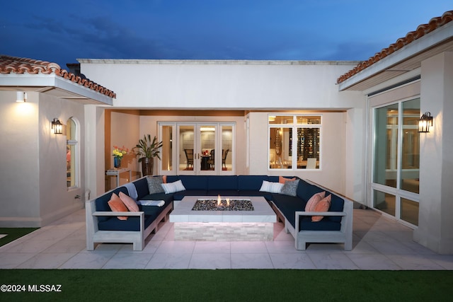 view of patio / terrace featuring an outdoor living space with a fire pit and french doors