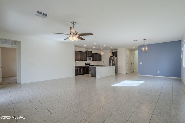 unfurnished living room with light tile patterned flooring, recessed lighting, ceiling fan with notable chandelier, visible vents, and baseboards