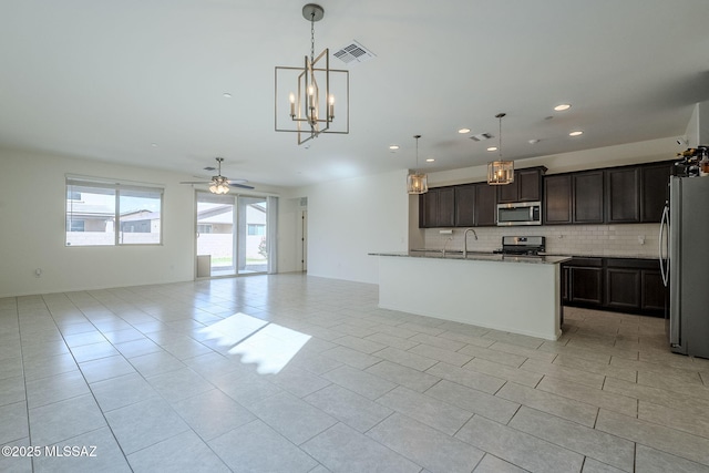 kitchen featuring light tile patterned floors, visible vents, open floor plan, appliances with stainless steel finishes, and tasteful backsplash