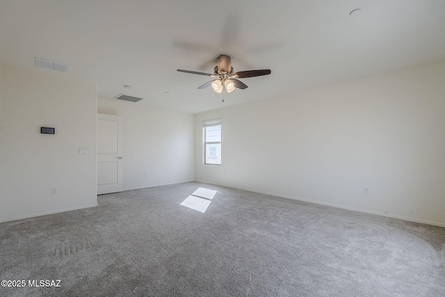 empty room featuring carpet floors, ceiling fan, visible vents, and baseboards