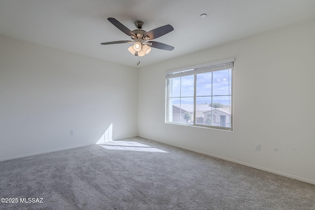 carpeted empty room featuring a ceiling fan