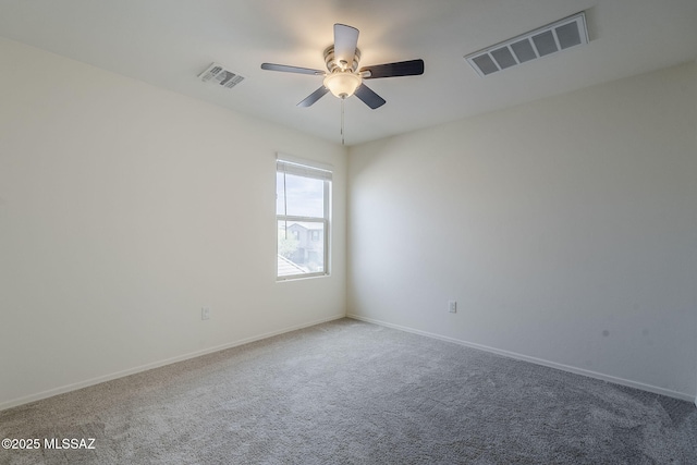 empty room featuring carpet floors, visible vents, baseboards, and a ceiling fan