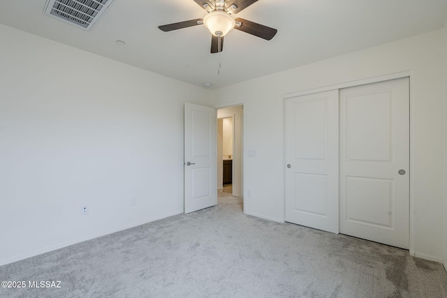 unfurnished bedroom featuring a ceiling fan, carpet, visible vents, and a closet