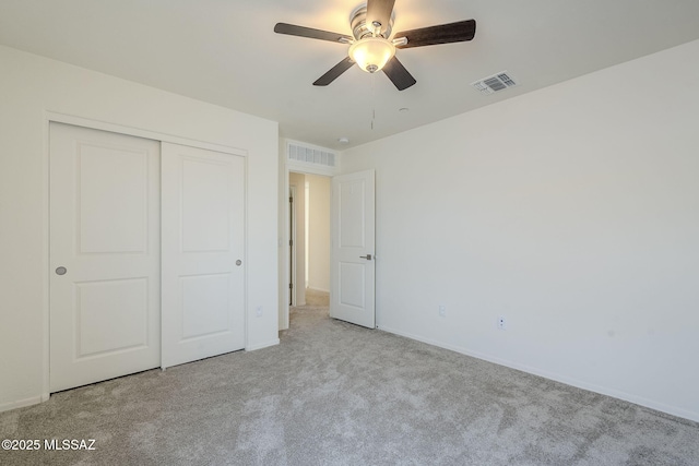 unfurnished bedroom with carpet floors, a closet, visible vents, and a ceiling fan