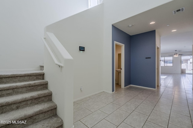 stairs featuring baseboards, visible vents, a ceiling fan, tile patterned floors, and recessed lighting