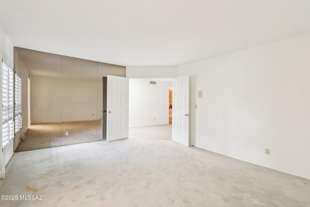 carpeted spare room with visible vents