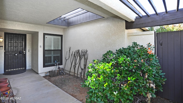 property entrance featuring a pergola