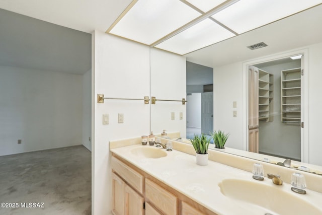 bathroom featuring a sink, visible vents, and double vanity