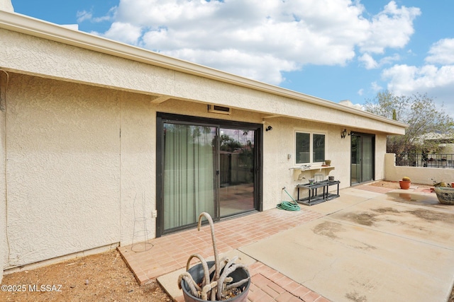 view of patio / terrace with an outdoor fire pit and fence