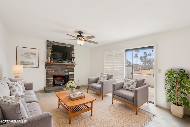 living room with a ceiling fan and a fireplace