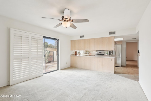 kitchen with a ceiling fan, light brown cabinets, visible vents, and appliances with stainless steel finishes