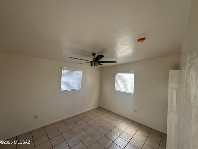 empty room featuring light tile patterned floors and ceiling fan