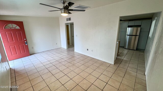 spare room featuring ceiling fan and light tile patterned floors