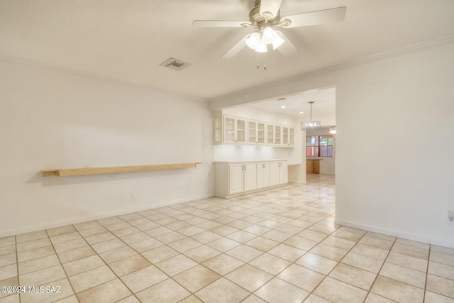 tiled empty room with crown molding and ceiling fan