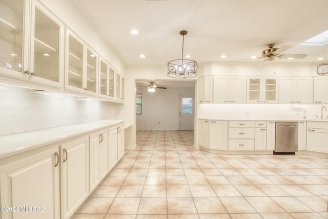 kitchen featuring light tile patterned floors, dishwasher, pendant lighting, decorative backsplash, and white cabinets