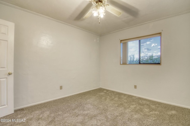 carpeted spare room with crown molding and ceiling fan