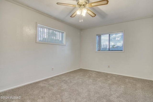 empty room featuring ceiling fan, ornamental molding, carpet flooring, and a wealth of natural light