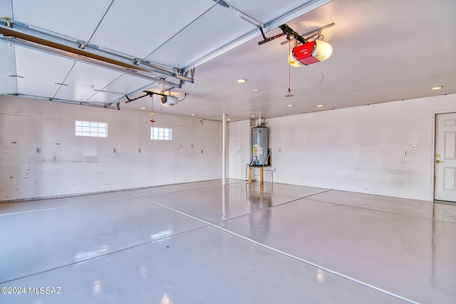 garage with a garage door opener and water heater