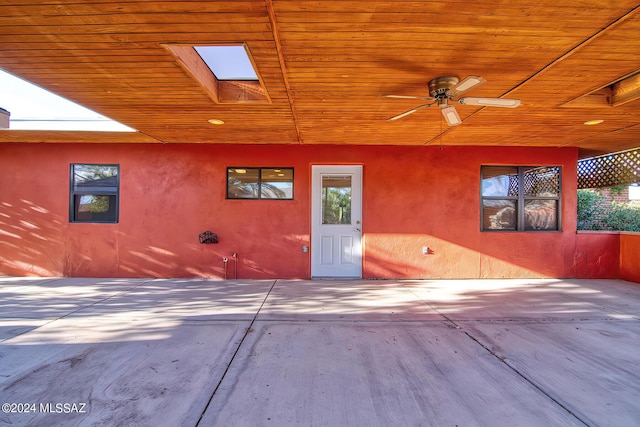 entrance to property with a patio and ceiling fan