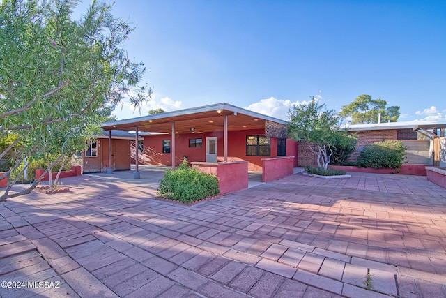 exterior space featuring ceiling fan