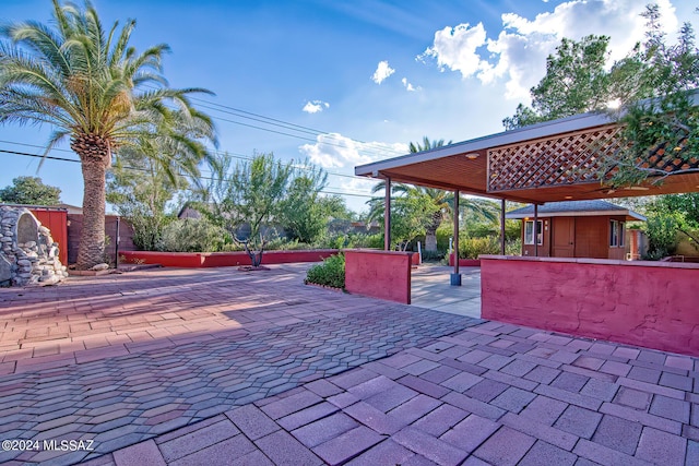 view of patio featuring a storage shed