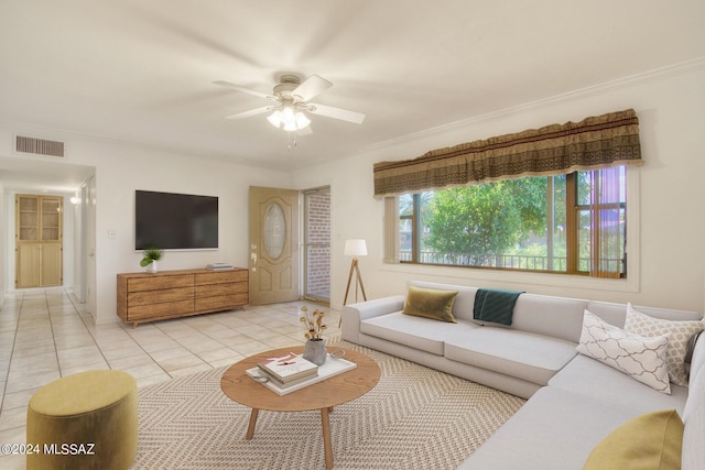 living room featuring light tile patterned flooring, ceiling fan, and ornamental molding