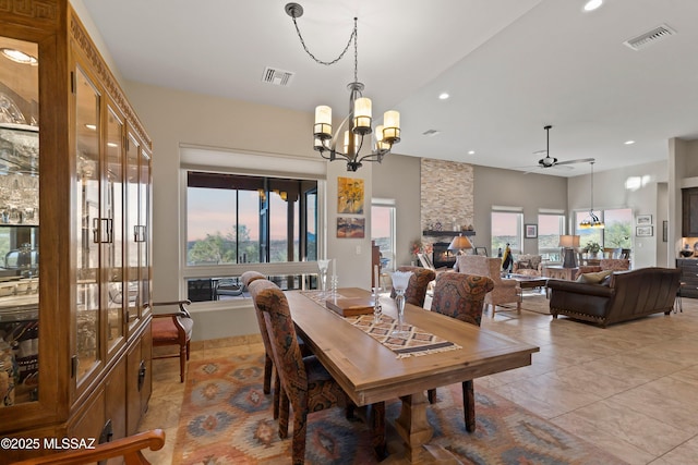 dining space with a chandelier, recessed lighting, visible vents, and a fireplace