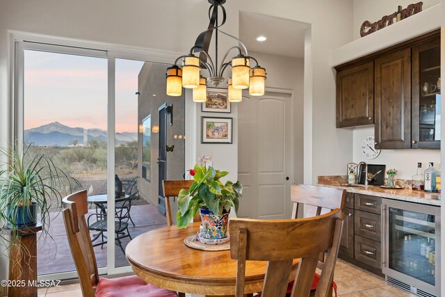 dining space featuring a mountain view and an inviting chandelier