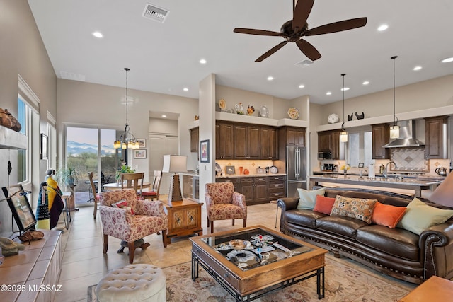 living area featuring light tile patterned floors, a high ceiling, visible vents, and recessed lighting