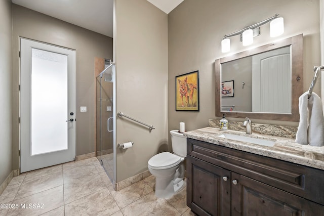 bathroom featuring toilet, vanity, and walk in shower