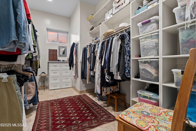 walk in closet with light tile patterned floors