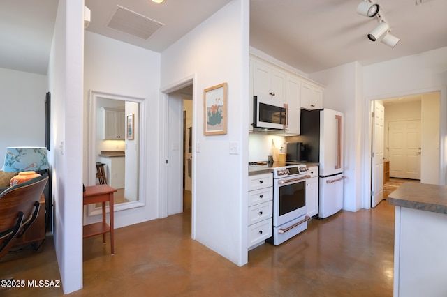 kitchen featuring white cabinetry, white appliances, and track lighting