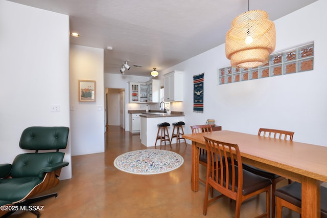 dining area featuring concrete flooring and sink