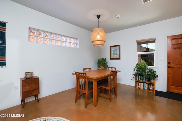 dining space featuring concrete floors