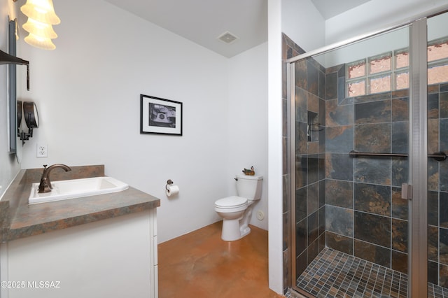 bathroom with toilet, a shower with shower door, and vanity