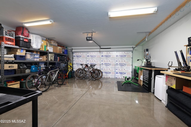 garage featuring a garage door opener and a workshop area