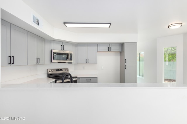 kitchen featuring gray cabinetry and stainless steel appliances