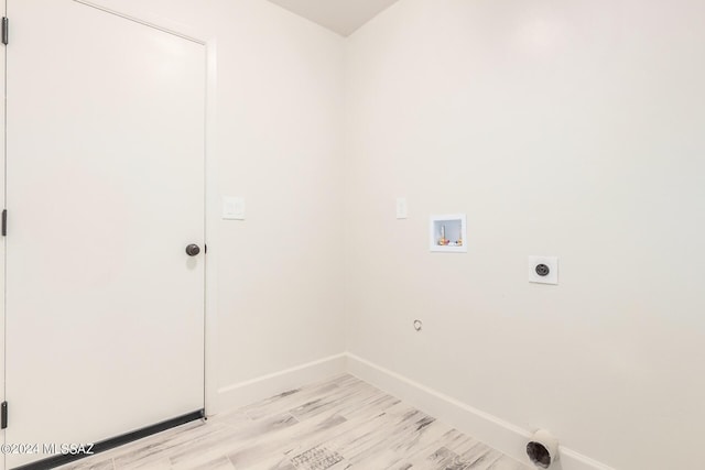 laundry area with electric dryer hookup, gas dryer hookup, light wood-type flooring, and hookup for a washing machine