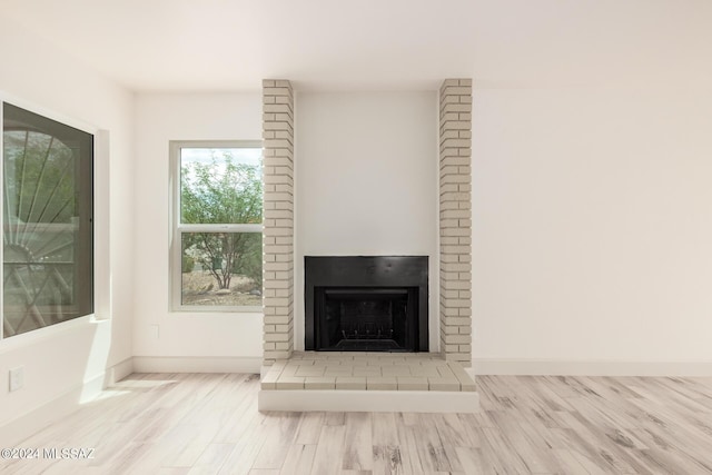 interior details featuring hardwood / wood-style flooring and a fireplace