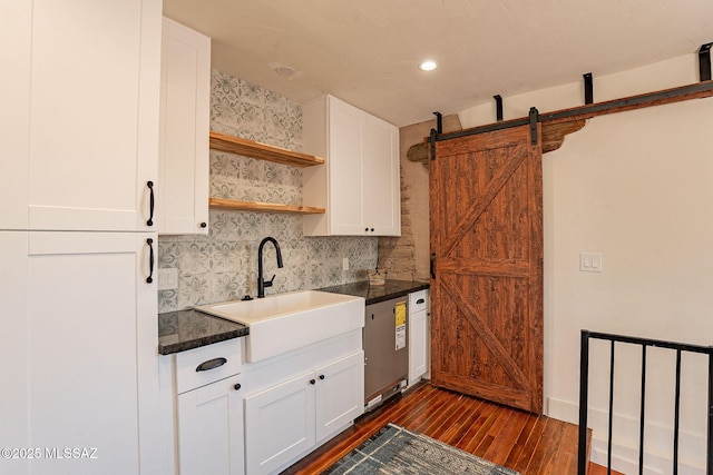 kitchen featuring white cabinetry, sink, dark hardwood / wood-style floors, and a barn door