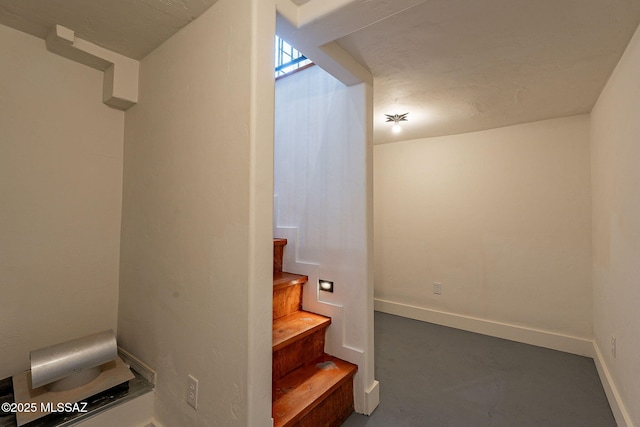 stairway with concrete flooring